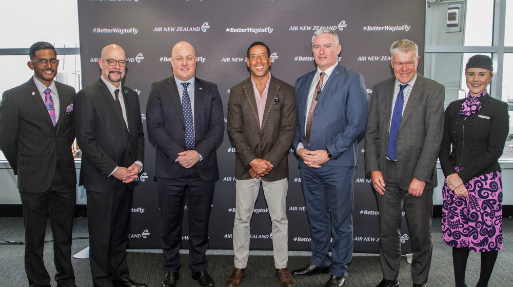 David Whittaker, Choose Chicago President & CEO; Christopher Luxon, Air New Zealand CEO; Rich Butler; Kelvin Davis, New Zealand Tourism Minister; Tony Carter, Air New Zealand Chairman - flanked by Air New Zealand cabin crew.