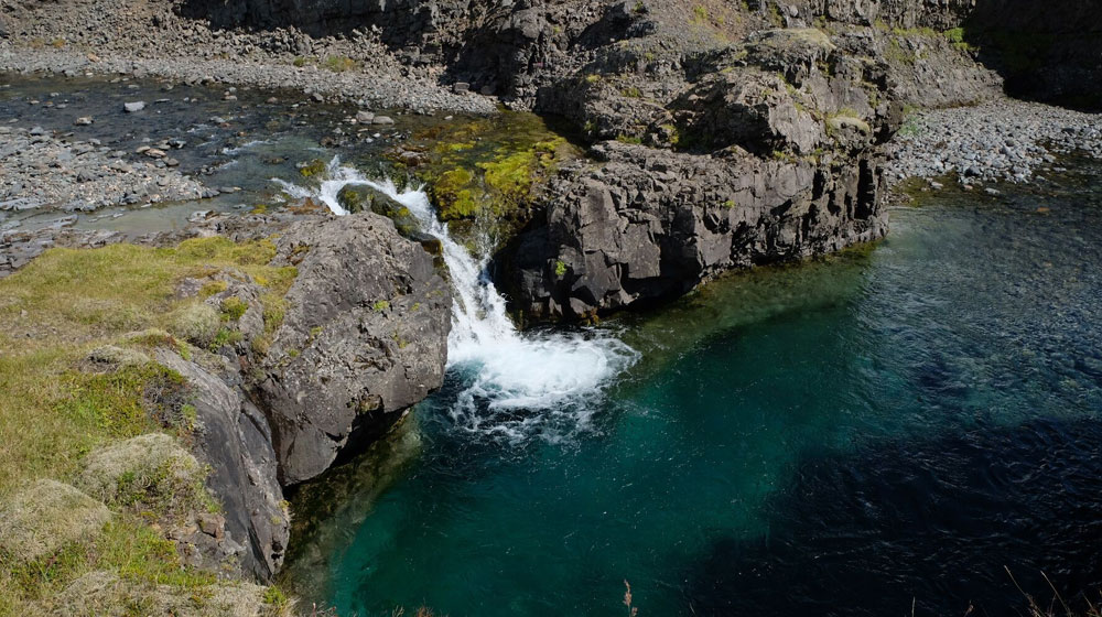 A waterfall withing the Össurá Valley